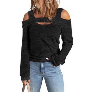Detail showing cold shoulder design and cutout neckline on dark gray knit top