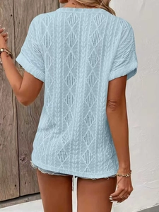 Detail of light blue knit top featuring hollow-out diamond pattern and textured weave