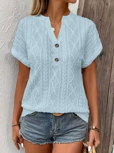Detail of light blue V-neck knit T-shirt with intricate hollow diamond textures and buttons