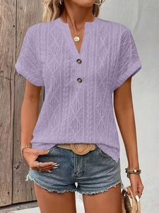 Detail of lavender knit V-neck top showing cable knit pattern and button accents