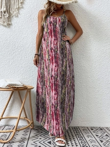 Detail of bohemian spaghetti strap maxi dress with colorful ethnic vertical stripes