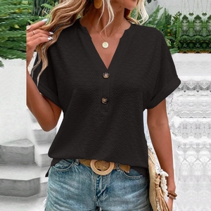 Detail of black V-neck t-shirt showing textured knit fabric and decorative front buttons