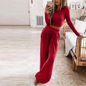 Women's two-piece ribbed knit lounge set featuring long sleeve crop top and wide leg pants