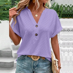 Detail of lavender V-neck top showing delicate textured knit fabric and button accents