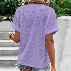 Detail showing the lavender textured fabric and rolled cuff design on a summer top