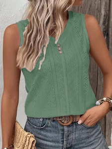 Close-up of green crochet knit top featuring hollow-out details and wooden buttons