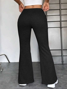 Vue arrière du pantalon de yoga évasé noir à taille haute avec coupe ajustée et sportive