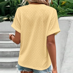 Rear view of pale yellow eyelet embroidery top with rolled short sleeves and summer style