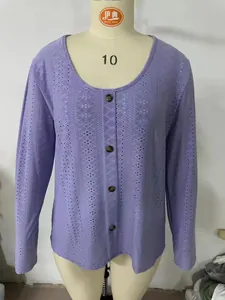 Detail view of purple long sleeve top with geometric hollow-out pattern and buttons