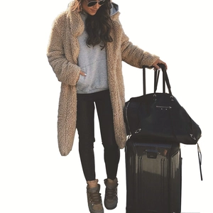 Detail view of a long camel teddy coat featuring wide lapels and soft plush texture