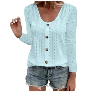 Detail of light blue knit top featuring delicate hollow-out texture and front buttons