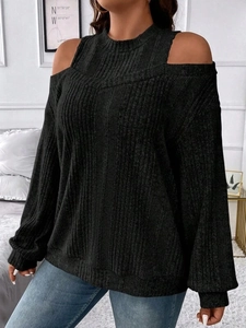 Close-up of black ribbed knit texture on a cold-shoulder top with a mock neck collar