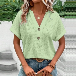 Light green short sleeve V-neck top with button details and textured crochet knit fabric