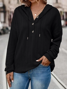 Women's black V-neck hoodie with buttons and waffle knit texture in loose fit