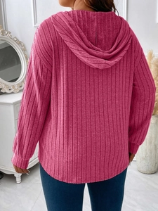 Back view of women's ribbed rose pink oversized hoodie with drawstring hood and knit texture