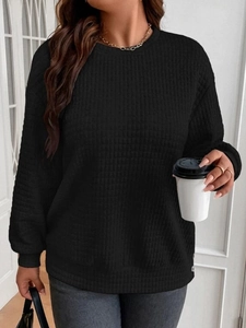 Detail of black crewneck sweatshirt with quilted waffle texture and ribbed cuffs for women