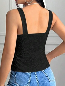 Detail of black slim fit tank top featuring 3D floral embossed texture and open back