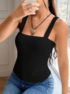 Close-up of black square neck tank top featuring elegant sunburst embossed fabric texture