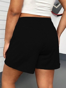 Rear view of black loose-fit athletic shorts featuring comfortable elastic high waist