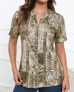 Detail of vintage leaf print short sleeve shirt with wooden buttons and V-neckline