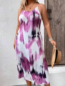 Detail of purple tie-dye maxi dress featuring deep V-neckline and boho holiday style
