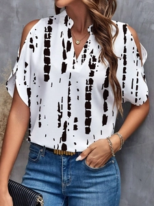 Detailed view of the V-neck and cold-shoulder cutouts on this floral print women's top