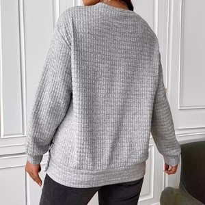 Women's oversized grey waffle knit sweatshirt with side buttons and crew neck