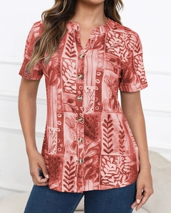 Close-up of terracotta bohemian shirt featuring ethnic leaf prints and vintage buttons