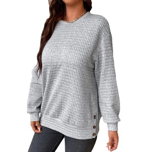 Women's light grey waffle knit crewneck pullover with side button details and long sleeves