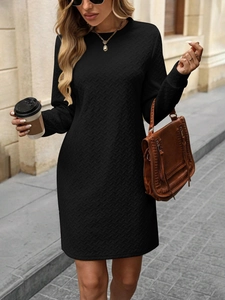 Detail of black long sleeve dress featuring textured herringbone knit and round neckline