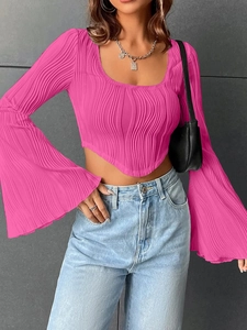 Bright magenta U-neck cropped top with flared long sleeves and textured ribbed fabric