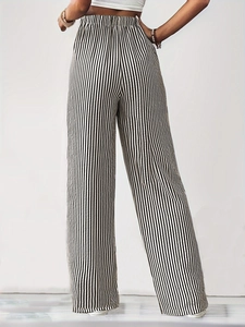 Detailed back view of high-waisted wide-leg trousers with vertical black and white stripes