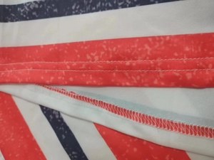 Detail of red, white, and blue striped fabric showing double-needle stitching and seams