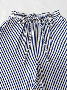 Detailed macro view of blue vertical striped casual pants with elastic drawstring waist