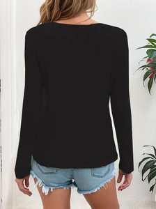 Detail of black waffle knit long sleeve top with textured fabric and casual fit style