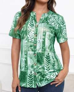 Detail of green leaf print short sleeve shirt with v-neck and wooden buttons