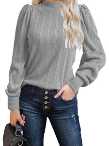 Close-up of grey knit sweater with puff sleeves and ribbed texture on the cuff