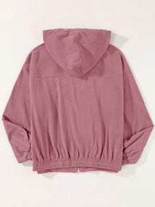 Detail of pink corduroy hooded jacket showing texture, ribbed hem and drop shoulder design