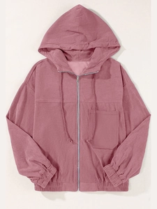 Detail of mauve corduroy zip-up hoodie featuring vertical rib texture and chest pocket