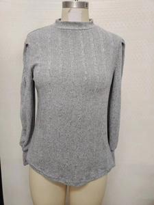 Detail of grey mock neck knit shirt with vertical ribbed texture and pleated shoulders