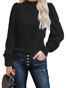 Detail shot of the vertical ribbed texture and mock neck on a black long-sleeved knit top