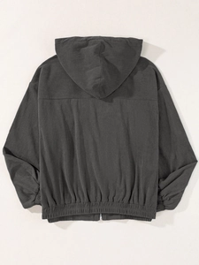 Detail view of the back of a charcoal grey corduroy hooded jacket with elastic cuffs