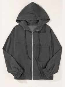 Detailed view of dark grey corduroy jacket featuring a zip-up front and drawstring hood