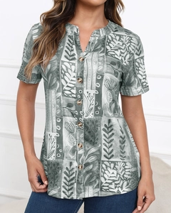 Close-up of tropical leaf print patchwork and wooden buttons on casual short sleeve shirt
