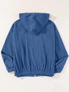 Back view detail of blue corduroy hooded jacket with elastic hem and ribbed texture