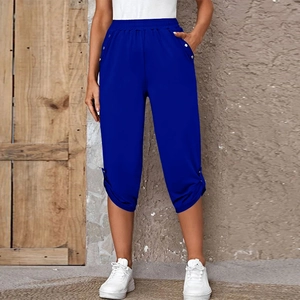 Detail of dark blue women's capris showing elastic waist and silver button decorations