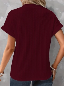 Close-up of wine red vertical stripe knit texture and hem detail on women's t-shirt