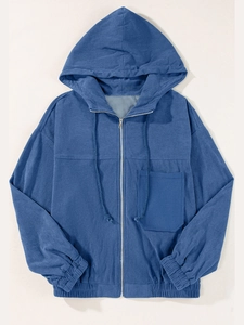 Detail of navy corduroy hooded jacket with metal zipper, drawstring, and texture