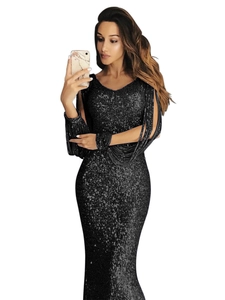 Detail of V-neck sequined black evening gown with elegant fringe on long sleeves