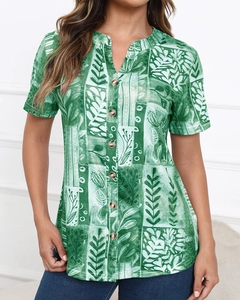 Detail of green V-neck short sleeve shirt with abstract leaf print and button closure